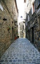 The perspective of a narrow straight street in the village, flanked by tall buildings, Bolsena, Tuscia, Lazio, Italy