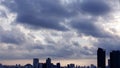 The perspective of nimbus clouds in the sky covers the city.