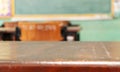 Perspective old brown wooden student`s desk