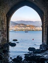 Perspective of the old shipyard Tersane through stone arches in Turkish Alanya to the sea bay. Vertical Royalty Free Stock Photo