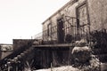 Perspective of old typical house with balcony, flower pots and stairs, Portugal