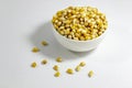 Perspective shoot of corn seeds in white small cup with natural concept