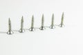 Perspective shoot of diagonal positioned multiple screws on white background