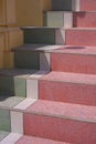 Perspective side view of colorful terrazzo stone steps of the old vintage staircase with sunlight and shadow on surface in