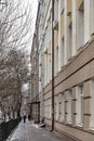 Perspective of the simple facade of a city house on a dim winter day