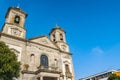 Stained glass window and balcony in perspective of the facade of the Basilica of the Sacred Heart of Jesus with two bell towers Royalty Free Stock Photo