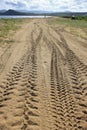 Perspective of tyre tracks on sandy beach