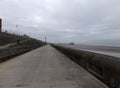 Perspective view along the pedestrian promenade in blackpool with a view of the town south pier and tower in the distance