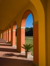 Perspective view of an arched walkway in a sunny day Royalty Free Stock Photo