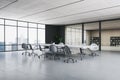 Perspective view on big white meeting table surrounded by wheel chairs in the center of meeting room with grey concrete floor and Royalty Free Stock Photo