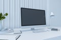 Perspective view on blank dark monitor screen with place for your logo or text in modern office with white table surface, white