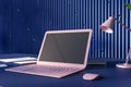 Perspective view on blank dark screen with space for your logo on modern pink laptop on dark table with notebooks and stylish lamp Royalty Free Stock Photo