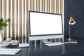 Perspective view on blank white computer monitor with empty place on dark work table with notebook, flower coffee pot on golden