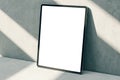 Perspective view on blank white digital tablet screen with space for logo brand or web design on sunlit concrete wall background Royalty Free Stock Photo