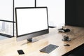 Perspective view on blank white modern computer monitor with space for web design or web page on wooden table with coffee cup on