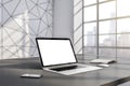 Perspective view on blank white modern laptop screen with place for your logo or text on table in sunlit modern interior