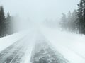 Perspective view from the car driving in a snowstorm on the Empty highway (asphalt road) in Finland, Poor visibility