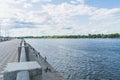 Perspective view of city embankment of Dnieper river in summer, Kiev, Ukraine. On waterfront fishermen are fishing