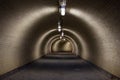 Perspective View Through a Dark Floodlighted Tunnel Royalty Free Stock Photo