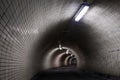 Perspective View Through a Dark Floodlighted Tunnel Royalty Free Stock Photo
