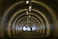 Perspective View Through a Dark Tunnel With Human Silhouette