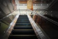 Perspective view of empty escalator in shopping center show nobody because of economics problems with dark edges all alround for Royalty Free Stock Photo