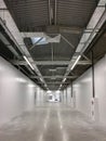 Perspective view of an empty hangar hall under construction with communications on the ceiling. Industrial warehouse Royalty Free Stock Photo