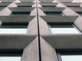 Perspective view of geometric angular concrete windows on the facade of a modernist 1960s brutalist style building