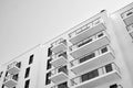 Fragment of a facade of a building with windows and balconies. Black and white. Royalty Free Stock Photo