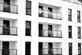 Fragment of a facade of a building with windows and balconies. Black and white. Royalty Free Stock Photo