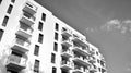 Fragment of a facade of a building with windows and balconies. Black and white. Royalty Free Stock Photo