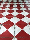 Perspective view of geometric floor background with red and white rhombuses. Red and white retro square tiles. Closeup of red and Royalty Free Stock Photo