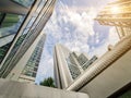 Perspective view high rise real estate of hotel apartment condo tower building with cloud blue sky and sun flare background Royalty Free Stock Photo