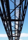 Perspective view of an industrial steel pipeline bridge built to carry water and gas across a river with an access walkway Royalty Free Stock Photo