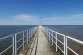 Perspective view of jetty with LED street light with solar cell on clear blue sky. Royalty Free Stock Photo