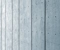 Perspective view of a large blue textured concrete wall with black vertical lines and a pattern of repeating dots