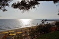 A perspective view of a large sea beach where tourists rest. Rows of sunbeds and beach umbrellas Royalty Free Stock Photo