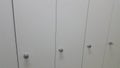 Perspective view of lockers or cupboards in a row with white doors Royalty Free Stock Photo