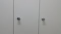 Perspective view of lockers or cupboards in a row with white doors Royalty Free Stock Photo