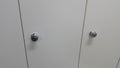 Perspective view of lockers or cupboards in a row with white doors Royalty Free Stock Photo