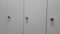 Perspective view of lockers or cupboards in a row with white doors Royalty Free Stock Photo