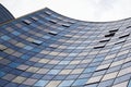 Perspective view of the modern glass building facade with clouds reflections on the windows Royalty Free Stock Photo