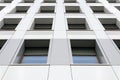 Perspective view of the modern gray building facade with windows. Architectural pattern Royalty Free Stock Photo