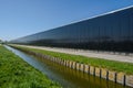 Perspective view of a modern industrial greenhouse with solar panels at the side in the Netherlands Royalty Free Stock Photo