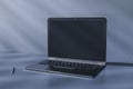 Perspective view on modern laptop blank dark screen with space for your logo or text on glossy surface table with pen on grey wall