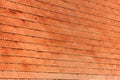 Perspective view of old red brick wall in sunlight for background. Royalty Free Stock Photo
