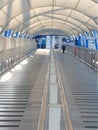 Perspective view of pathway with silver color handrails in the middle and white canvas roof Royalty Free Stock Photo