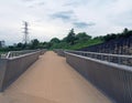 View of the pedestrian footbridge crossing the weir on the river aire at knostrop leeds with electricity pylons in a Royalty Free Stock Photo