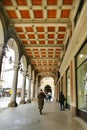 Perspective view of picturesque ancient arcades of city downtown Turin Italy
