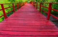 Perspective view of red-aged-wooden bridge in a garden, vintage wooden walkway bridge, no people Royalty Free Stock Photo